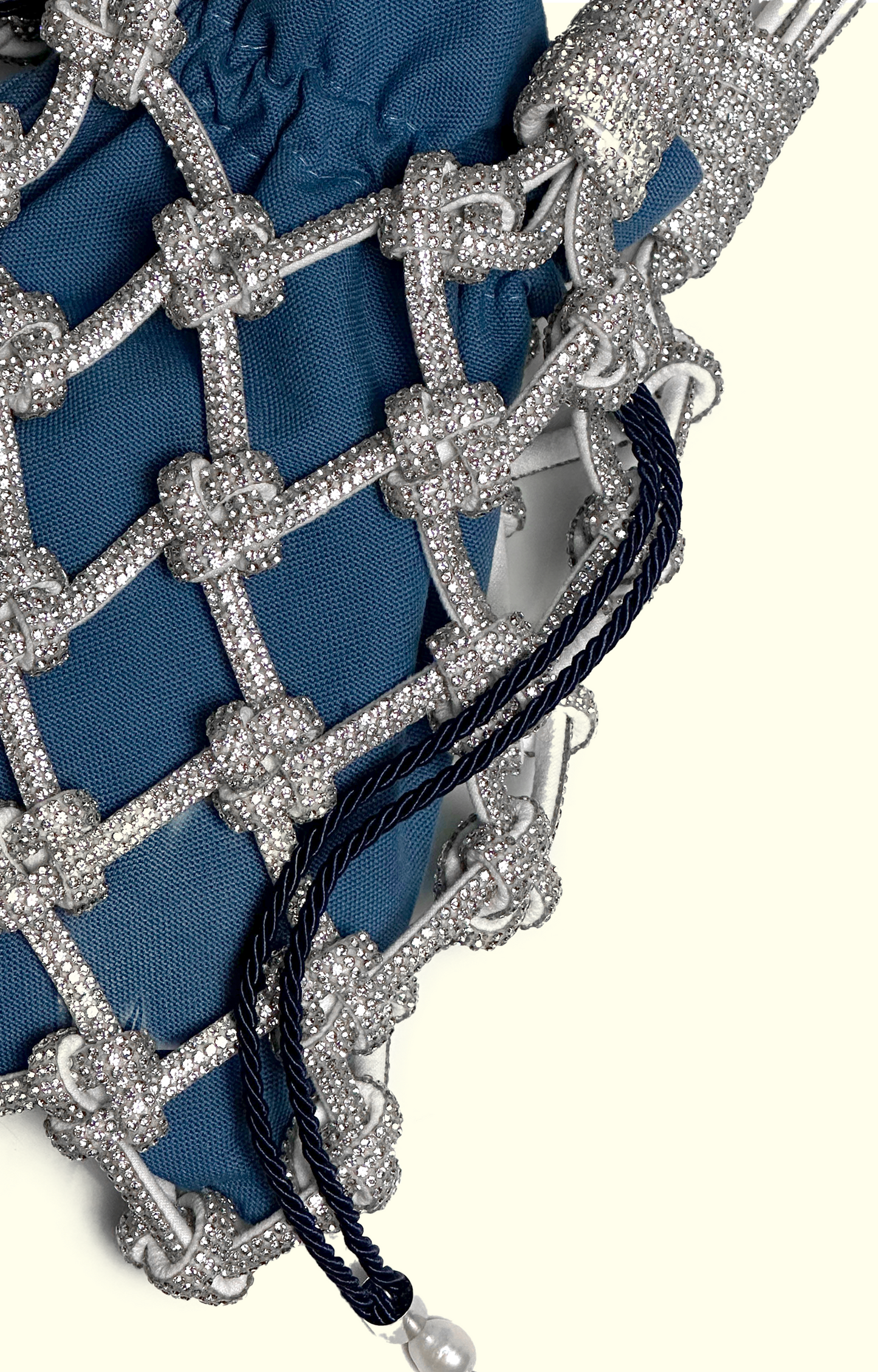 Blue denim drawstring pouch inside a rhinestone net bag