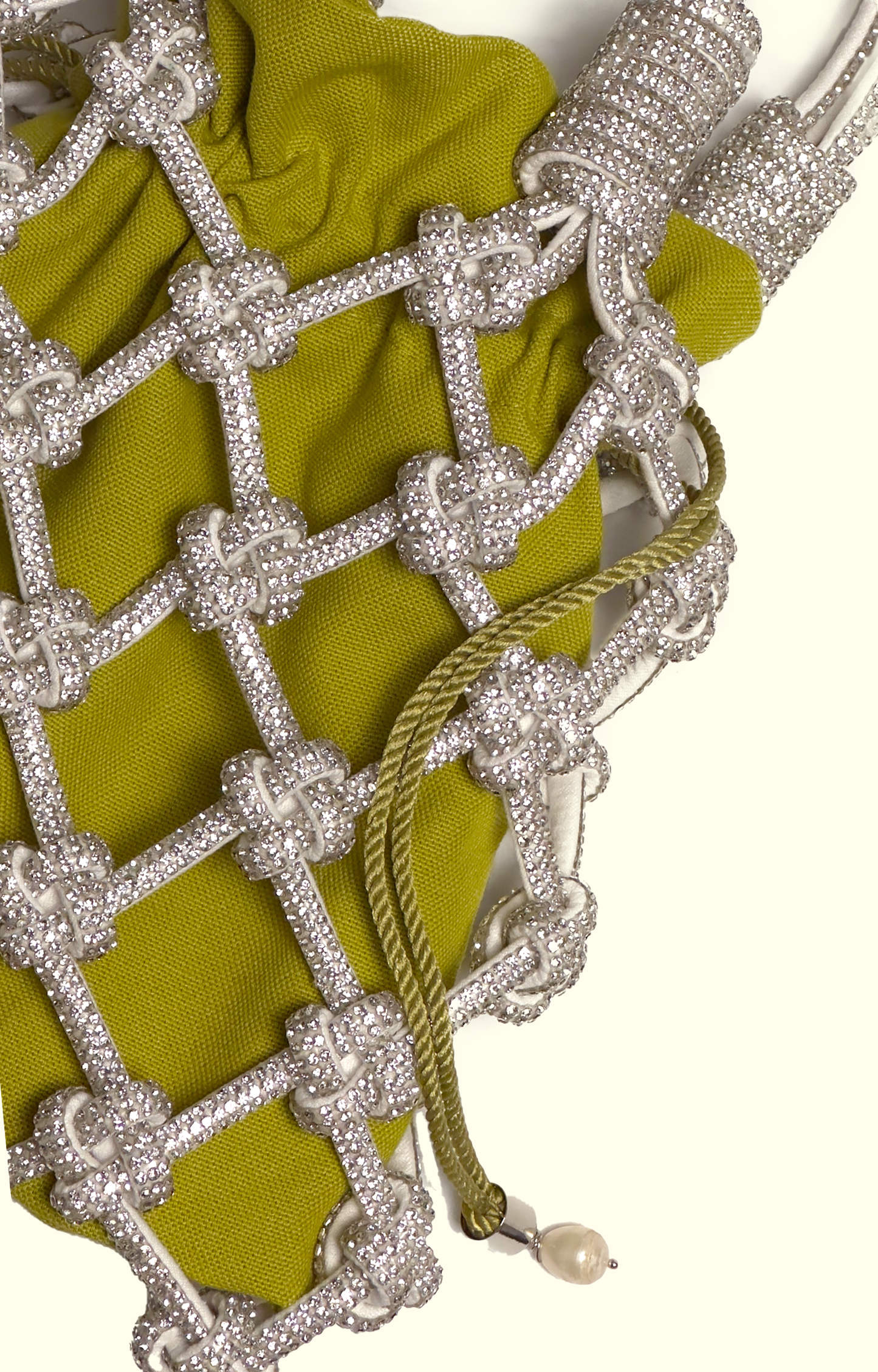 Yellow drawstring pouch inside a rhinestone net bag
