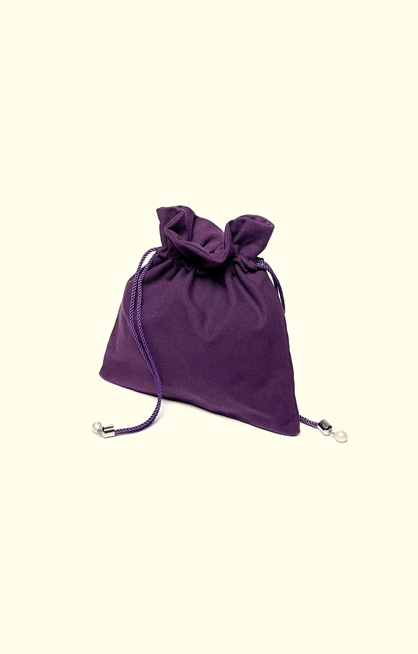 Purple drawstring bag on a beige background
