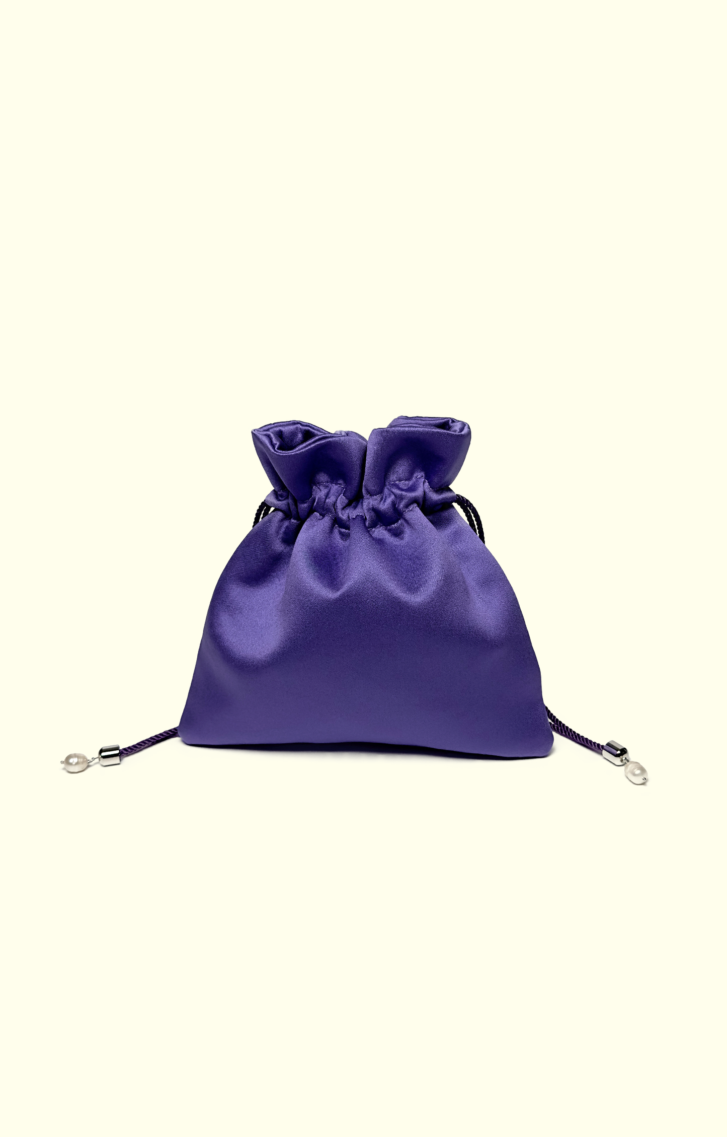 Purple satin drawstring bag on a white background