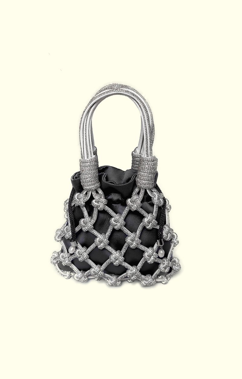 Black satin drawstring pouch inside a rhinestone net bag