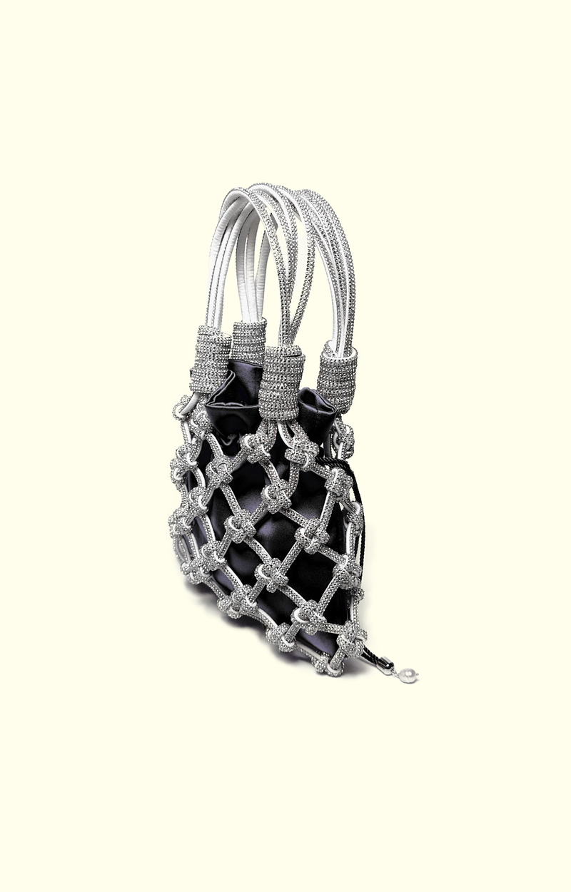 Black satin drawstring pouch inside a rhinestone net bag