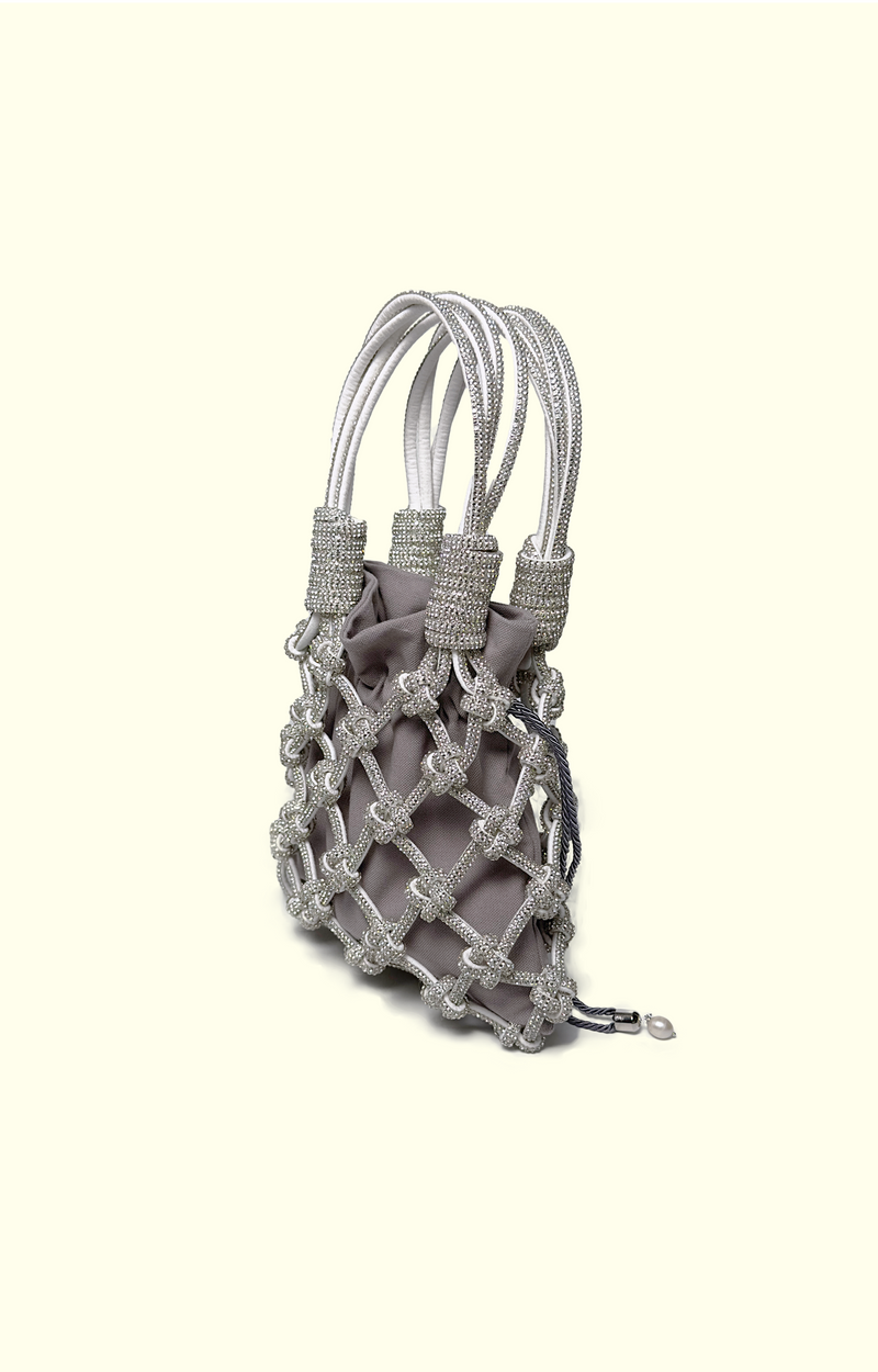 Grey drawstring pouch inside a rhinestone net bag