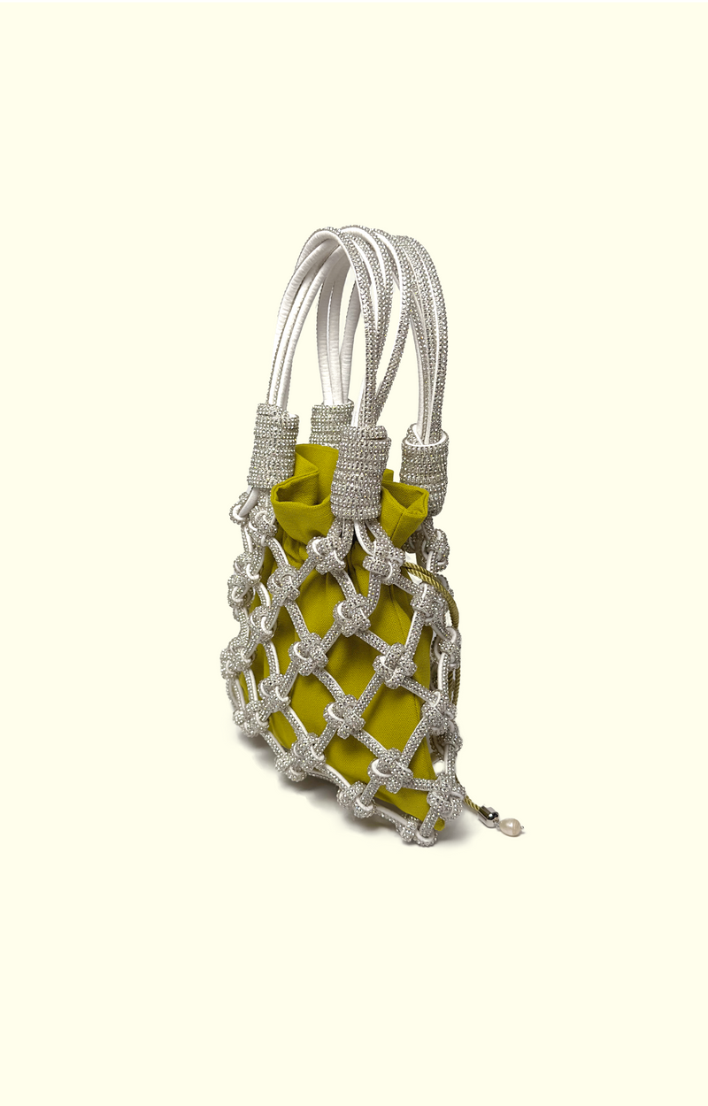 Yellow drawstring pouch inside a rhinestone net bag
