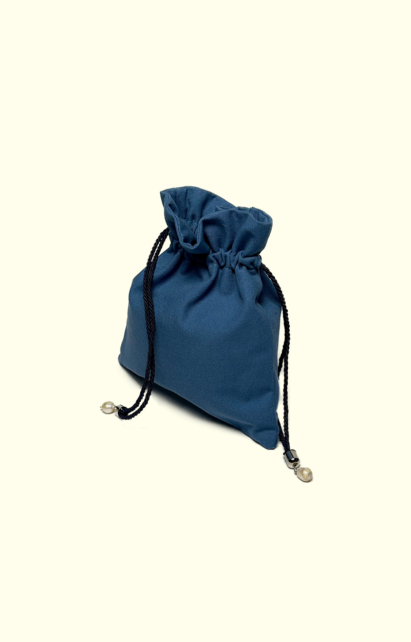 Blue drawstring pouch on a beige background