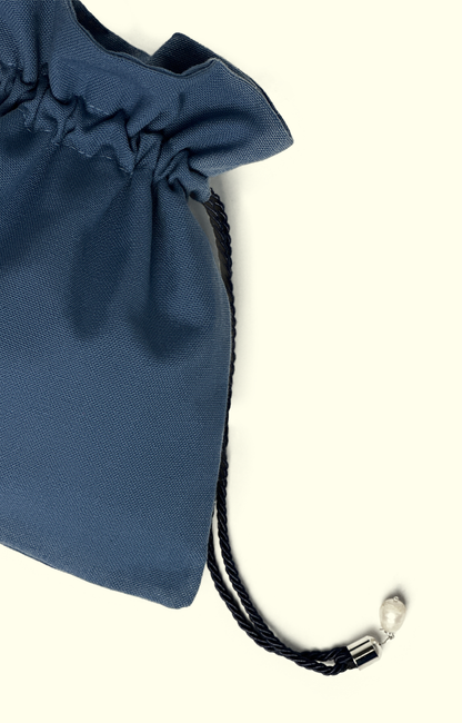 Blue drawstring bag with a black strap on a white background