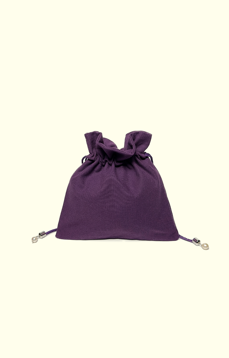 Purple drawstring bag on a white background