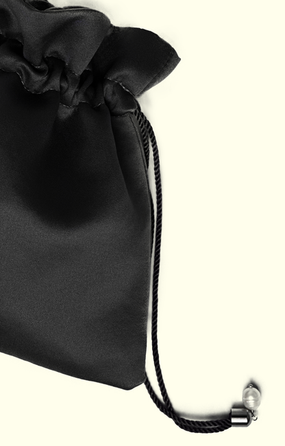 Black satin drawstring bag with a metal clasp on a white background