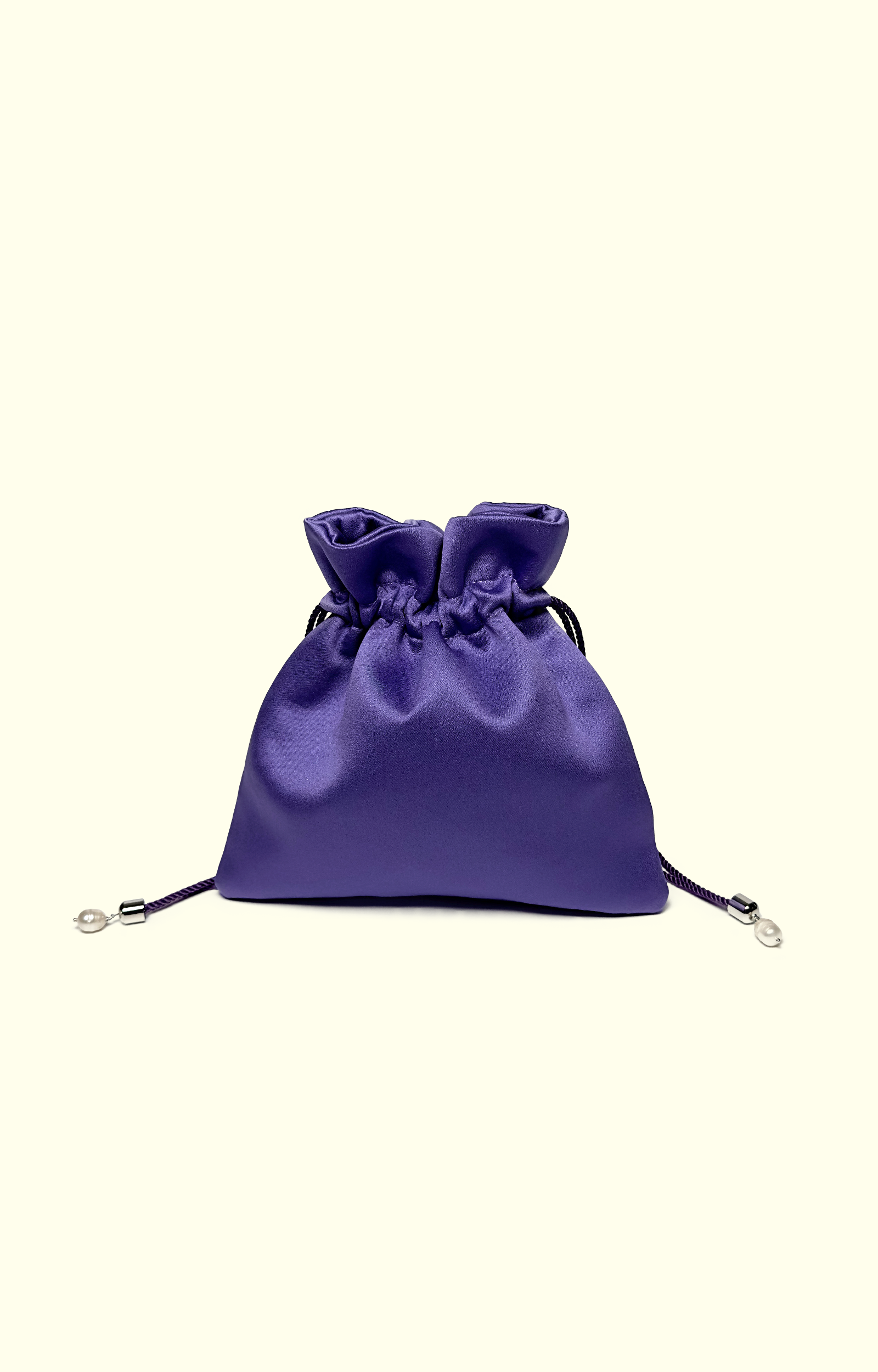 Purple satin drawstring bag on a white background